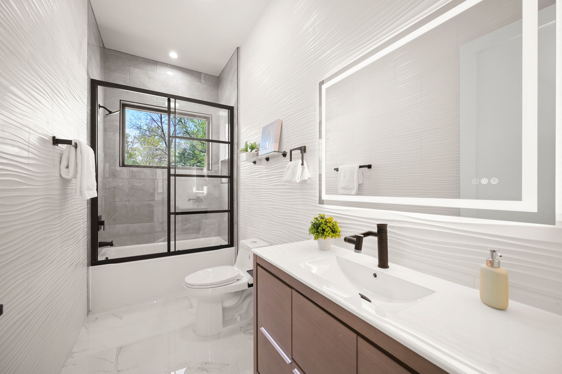 Modern bathroom with illuminated mirror